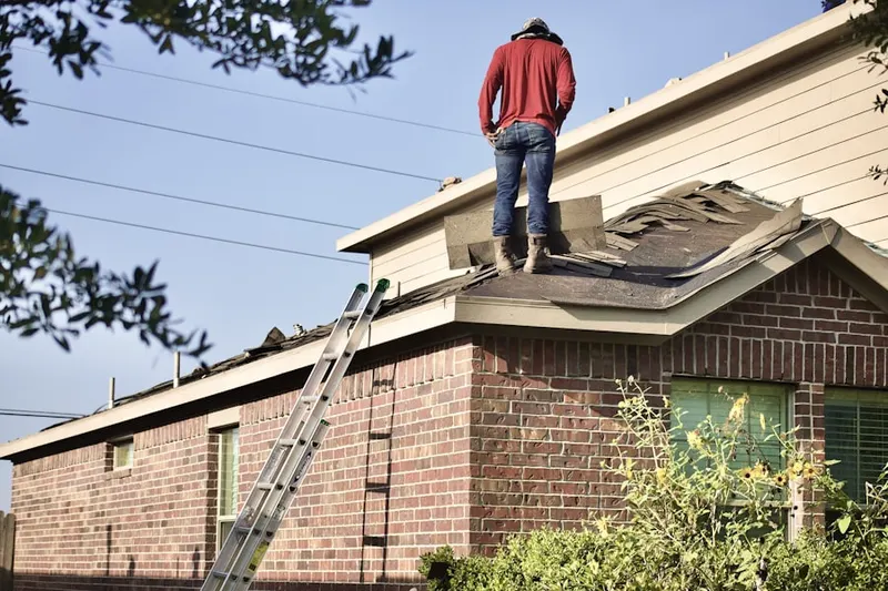 Professional roofer working on a residential roof in Socialville